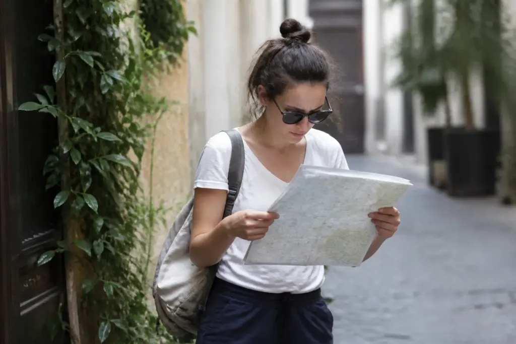 Touriste avec sac consulte une carte papier